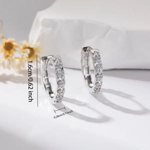 Detail view of silver zircon earrings with size markings 1.6cm by 0.28cm on white background