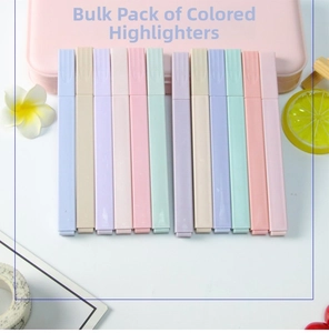Flat lay of 12 macaron pastel highlighters with square barrels on a soft pink background