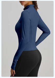 Detail showing the Prussian blue long-sleeve sports jacket with slim-fit seams