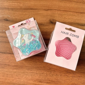 Detail of star-shaped hair brush set featuring floating sequins and soft massage bristles
