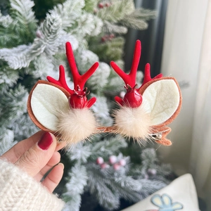 Cute Christmas reindeer antler hair clips with white ears and soft beige pompom details