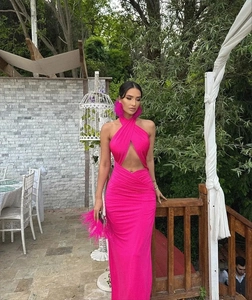 Detail of fuchsia backless halter dress with criss-cross neckline and pleated fabric texture