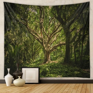 Detail view of large bohemian forest tapestry hanging on wall with lifelike green ancient tree