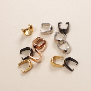 Macro view of assorted stainless steel pinch bails for DIY jewelry making in multiple finishes