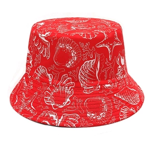 Detail of red bucket hat featuring white marine life patterns like shells and corals