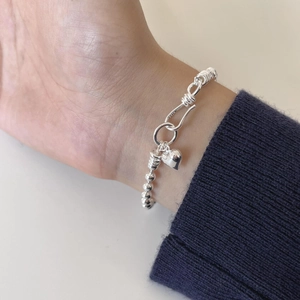 Minimalist 925 sterling silver beaded bracelet with heart pendant shown on a wrist