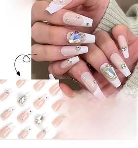 Macro detail of French style press-on nails with sparkling crystals and white tips