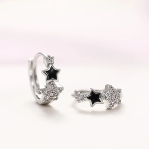 Silver star hoop earrings with black enamel detail and sparkling cubic zirconia stones