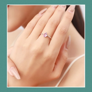 S925 sterling silver minimalist ring featuring a pear-cut pink gemstone on a finger