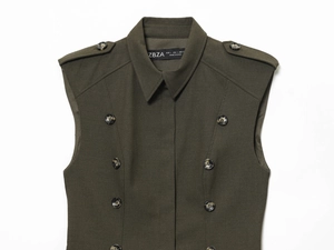 Detail of army green sleeveless dress featuring double-breasted buttons and epaulettes