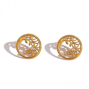 Detailed close-up of golden Tree of Life earrings with tiny inlaid rhinestones