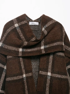 Detail of thick brown plaid knit cardigan with large checkered pattern and textured fabric