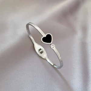 Silver stainless steel open bangle with black heart charm and sparkling small crystal