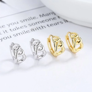 Detail view of 925 sterling silver and gold twist chain hoop earrings in two finishes