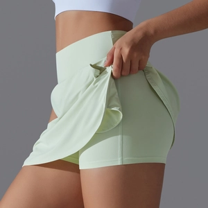 Detail of high-waisted cooling tennis skort in light green showing double-layer structure