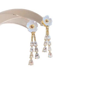 Elegant gold earrings with white flowers and long sparkling crystal drop tassels