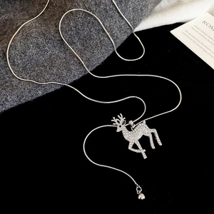 Detailed view of silver deer pendant with sparkling crystals and elegant snake chain
