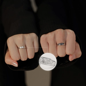 Angel and Demon couple rings set with wing motifs and zircon heart stones