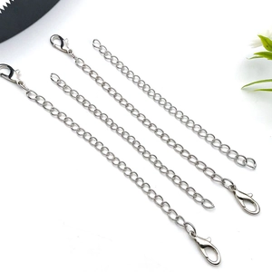 Detailed macro view of four silver metal keychain extension chains with lobster clasps