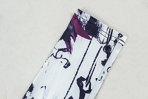 Detail of purple and black ink print on stretch knit fabric with durable double-stitch seams