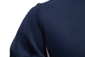 Detail of shoulder seam stitching on navy blue long-sleeve sweatshirt for men