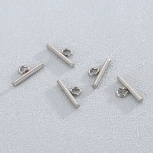 Macro detail of five silver stainless steel OT toggle bar connectors for jewelry making