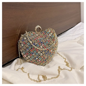 Detail of colorful rhinestones on a heart-shaped evening clutch bag with gold chain