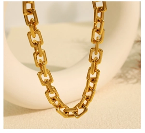 Detail of 18k gold plated chunky rectangular link chain necklace with polished finish