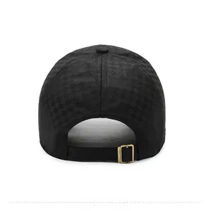 Detailed back view of a black checkered baseball cap with adjustable gold metal buckle