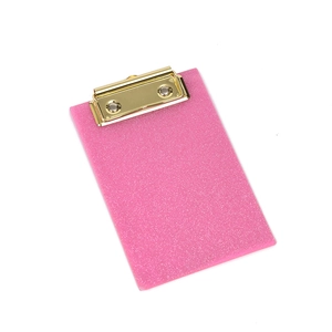 Detailed view of pink glitter acrylic clipboard with a premium gold metal spring clip