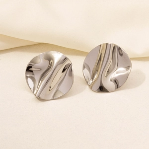 Detailed view of silver stainless steel earrings with irregular wavy texture surface