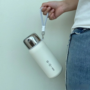 Minimalist matte white thermos flask with silver lid and grey woven carrying strap