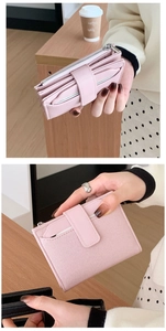 Detailed view of pink textured leather wallet with card slots and secure strap