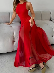 Detail of red sleeveless gown with sheer mesh slit hem and elegant slim fit style