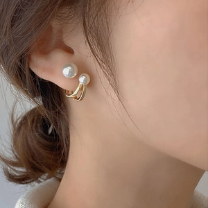 Elegant 925 silver pearl stud earrings with gold-plated double-C design on model