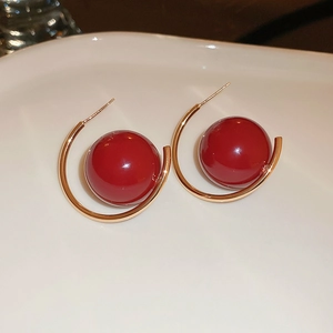 Elegant gold hoop earrings featuring vibrant red pearls and sparkling cubic zirconia details