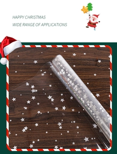 Close-up of waterproof transparent Christmas cellophane wrap with white star patterns