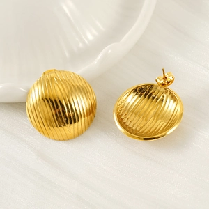 Chic golden geometric ribbed dome stud earrings for women on a shell decorative plate