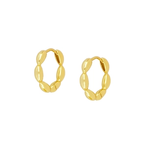 Macro view of gold hoop earrings with polished oval links on a clean white background
