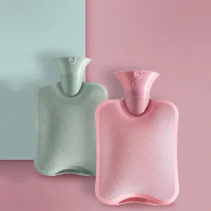 Durable PVC hot water bottles in mint green and pink with anti-slip texture and leakproof seal