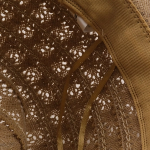 Detailed close-up of woven raffia straw hat showing inner sweatband and ribbon strap