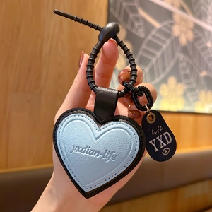 Light blue heart leather keychain pendant with black strap and small decorative tag