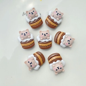 Detailed view of miniature resin figurines featuring cats and hamsters in cupcakes