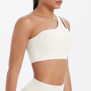 Detail of white one-shoulder sports bra made with premium matte stretch fabric
