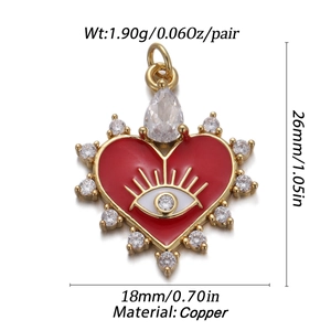 Detailed view of gold heart evil eye pendant with red enamel and zircon stone inlay