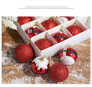 Detail of red glitter and Santa belt themed Christmas ball ornaments in white box