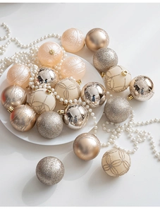Detail of elegant champagne Christmas baubles with varied textures in a decorative tray
