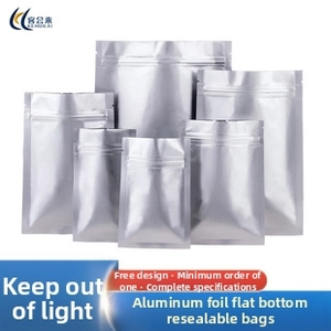 Macro detail of matte silver aluminum foil ziplock bags showing seal and tear notch