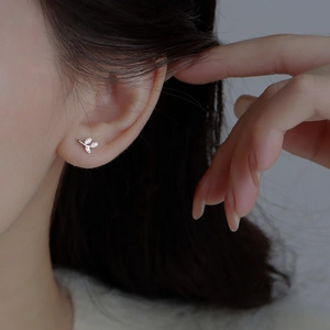 S999 sterling silver leaf stud earring with sparkling diamonds shown on ear model