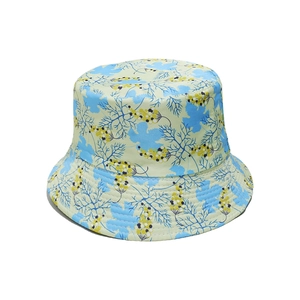 Close-up of floral bucket hat with blue and yellow botanical print on light green fabric